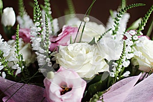 Delicate beautiful wedding bouquet with white roses and pink eu