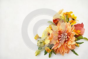 Delicate blossoming orange dahlia and yellow flowers, blooming festive fall frame background, autumn bouquet floral card
