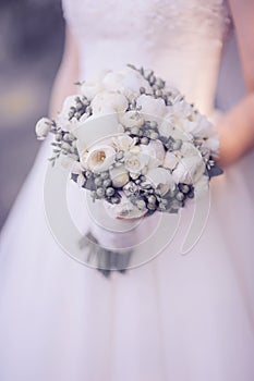 Delicate bouquet in hands of the bride