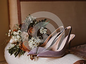 Delicate bridal bouquet and pair of elegant heels