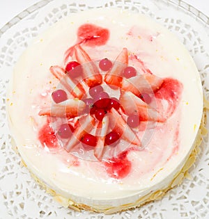 Delicate cake with strawberries and redcurrants