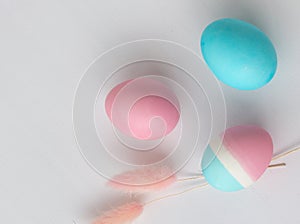 Delicate colors of Easter eggs on a white table, close-up
