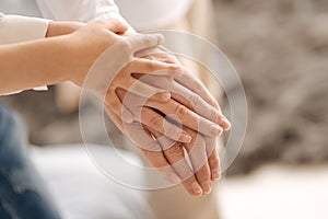 Delicate female hands of three generations