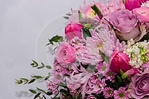 Delicate fresh bouquet of fresh flowers with pink Ranunculus, rose, astra and chrysanthemum.