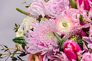 Delicate fresh bouquet of fresh flowers with pink Ranunculus, rose, astra and chrysanthemum.