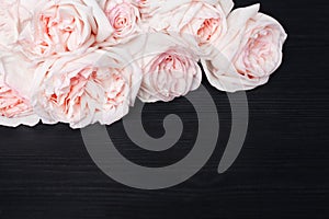 Delicate light pink roses black wooden background close up, beautiful white and red flowers bouquet on dark wood, greeting card