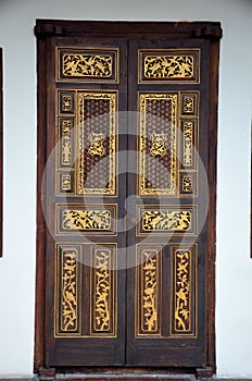 Delicate Peranakan wood carved door with gold inlay Penang Malaysia