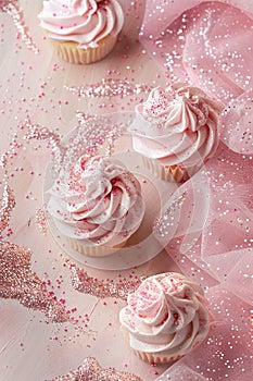 Delicate pink cupcakes with sparkling sprinkles, perfect for celebrating special occasions like baby showers, birthdays