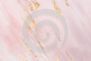 Delicate pink marble background with gold brushstrokes. Place for your design photo