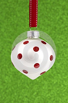 Delicate Red and White Glittery Christmas Ornament Hanging on a