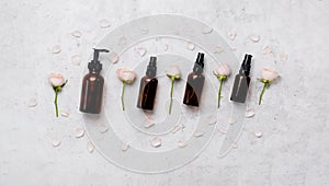 Delicate skin care cosmetic feminine flatlay. Top view Creative composition of face cream ,glass bottles and jars with cosmetic