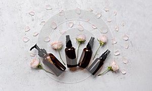 Delicate skin care cosmetic feminine flatlay. Top view Creative composition of face cream ,glass bottles and jars with cosmetic