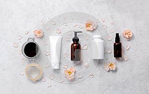 Delicate skin care cosmetic feminine flatlay. Top view Creative composition of face cream ,glass bottles and jars with cosmetic