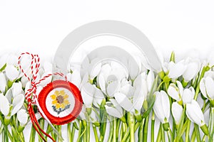 Delicate snowdrops on white with  martisor symbol 1st of march celebration concept
