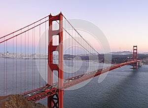 Delicate sunset hues behind Golden Gate Bridge