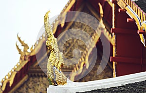 Delicate Thai art at roof top of Buddhist temple in Bangkok, Tha