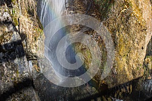 delicate waterfall with a rainbow