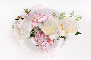 Delicate white pink peony with petals flowers and white ribbon on wooden board. Overhead top view, flat lay. Copy space
