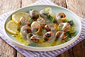 Delicatessen food: edible snails, escargot cooked with butter, p