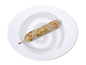 Delicios chicken lula kebab on a white plate.