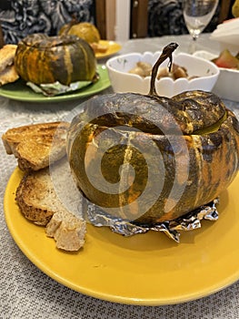 delicious appetizing healthy baked pumpkin with toasted bread on the dinner table beautiful food