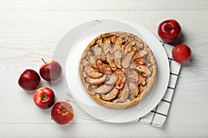 Delicious apple pie and fresh fruits on white wooden table, flat lay