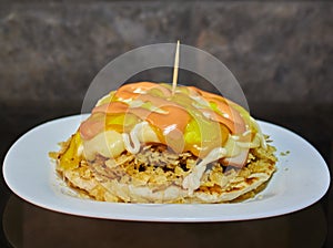 Delicious arepa burger with gratin cheese, french fries and all the sauces you want