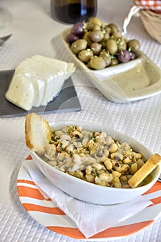 Delicious array of Portuguese starters: fresh bread, mild cheese, tempting olives, and tuna with black-eyed peas.
