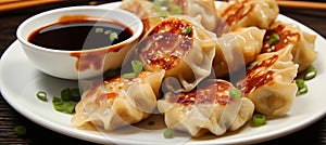 Delicious asian dumplings gyozas potstickers with soy onion sauce on white ceramic plate