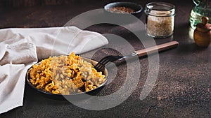 Delicious Asian pilaf with meat on a plate on the table web banner