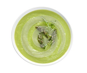 Delicious asparagus soup with arugula isolated, top view