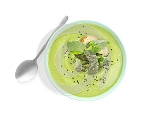 Delicious asparagus soup with basil and sesame seeds isolated, top view