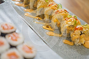 Delicious assorted Japanese sushi rolls on beautiful set up on table in traditional healthy Asian food and creative oriental