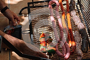 Delicious assorted sausages and chicken kebab on the grill