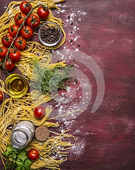 Delicious assortment of ingredients for cooking pasta with tomatoes, flour, butter, black pepper, herbs salt on wooden rustic