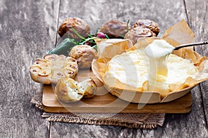 Delicious baked camembert with roasted potato and garlic