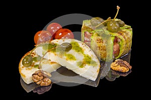 Delicious baked gourmet sheep cheese with walnuts with reflection
