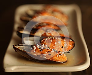 delicious baked mussles on white plate