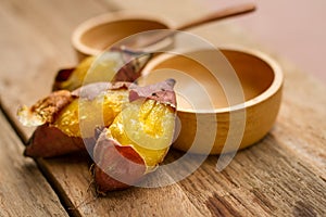 Delicious baked sweet potato with wooden spoon