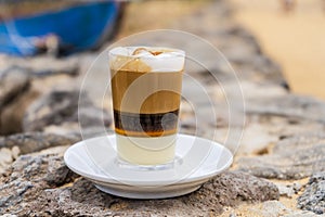 Delicious barraquito coffee with liquor and condensed milk, typical for Canary Island, Spain photo