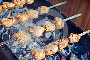 delicious bbq kebab grilling on open grill, outdoor kitchen. food festival in city. tasty food roasting on skewers, food