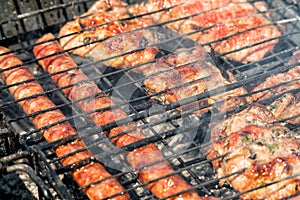 Delicious bbq kebab grilling on open grill, outdoor kitchen. tasty food roasting on skewers, food-court. summer picnic