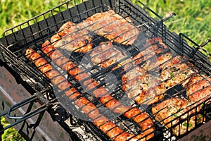 Delicious bbq kebab grilling on open grill, outdoor kitchen. tasty food roasting on skewers, food-court. summer picnic