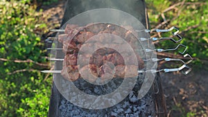 Delicious bbq kebab grilling on open grill on a summer day. Outdoor kitchen at the food festival in city. Tasty food