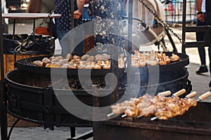 Delicious bbq potato and mushrooms roasting on open grill, outd