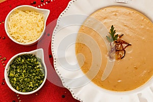 Delicious bean broth, Bean soup, with wooden background, red fabric background, with toast, parsley and parmesan, Brazilian winter photo