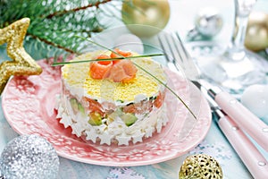 Delicious and beautiful layered salad with salted salmon, avocado, boiled egg and rice