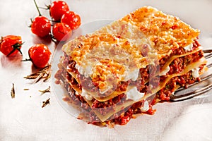 Delicious beef lasagne with roasted tomatoes photo