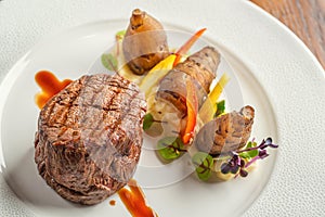 Delicious beef steak with sauce and vegetable, served on white plate, modern gastronomy, michelin restaurant