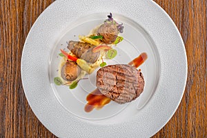 Delicious beef steak with sauce and vegetable, served on white plate, modern gastronomy, michelin restaurant